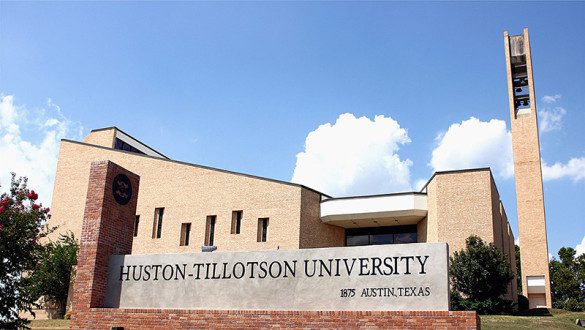 Huston-Tillotson University Marquee in foreground, building and clouds in background