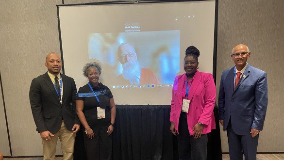 Group of people standing in front of projection screen