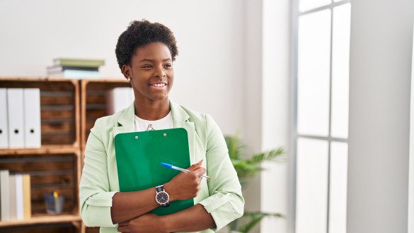 African american woman psychologist holding clipboard at psychology center