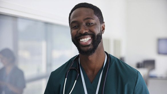 stock photo of a black man smiling in scrubs