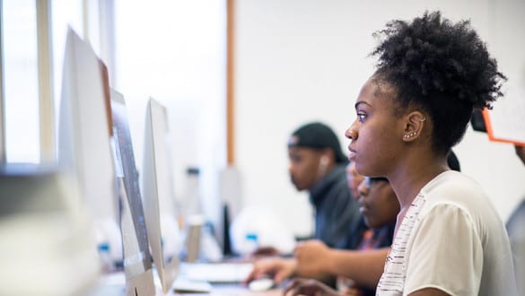 Female Claflin student sitting at a computer