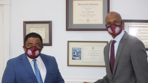 Dr. Hawkins with a trustee smiling and posing for camera