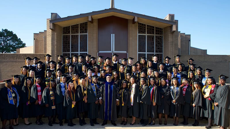 Jarvis Christian College graduates group shot in caps and gowns