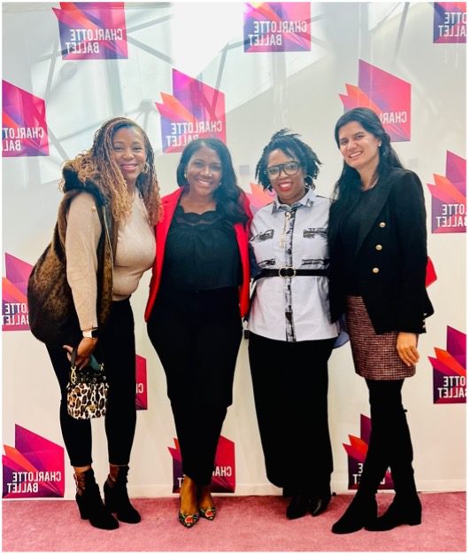 Four ladies standing in front of Charlotte Ballet step and repeat.