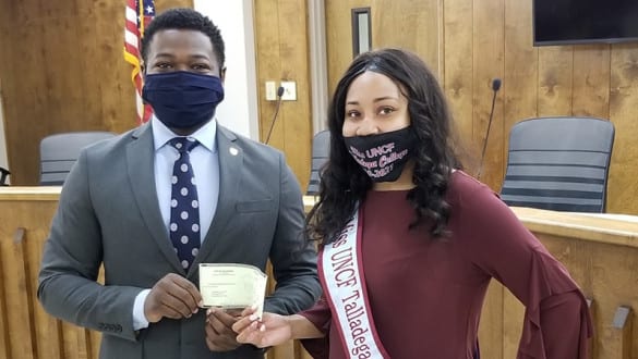 Miss UNCF Talladega College accepting donation check from Talladega Mayor.