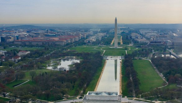 Aerial view of the National Mall in Washington, D.C. The reflecting pool and Washington Monument are visible.