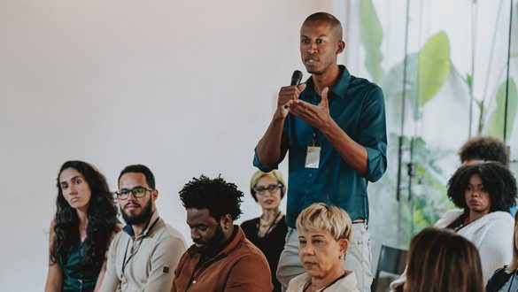 a speaker addressing an audience during a discussion