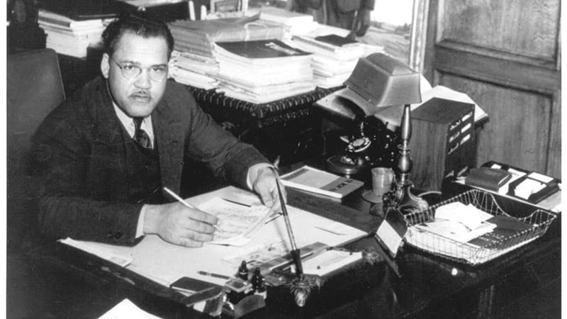 Frederick D. Patterson sitting at desk