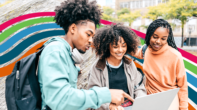 Group of students smiling with fidelity colors in the background