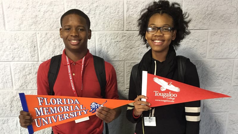 boy and girl with school banners