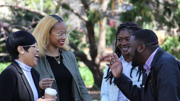 Group of four college students laughing