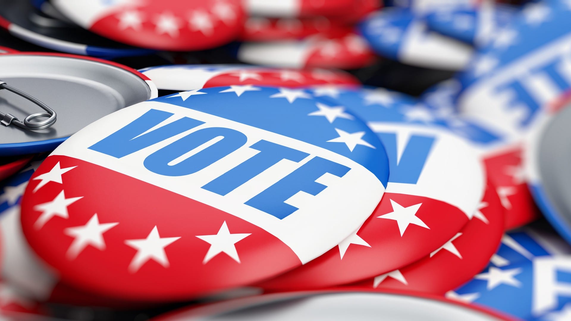 Pile of lapel pin buttons that say vote