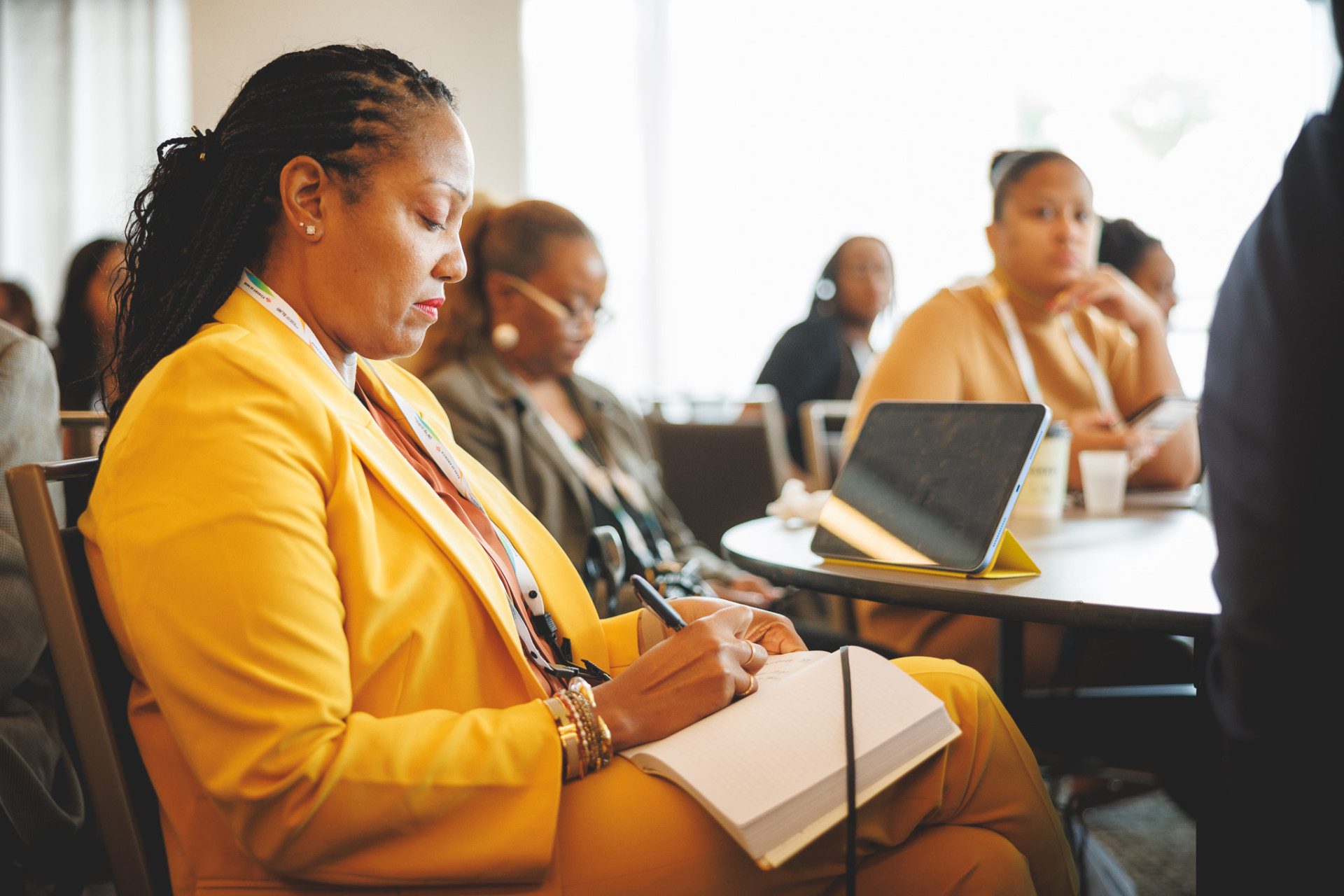 Woman takes notes during conference