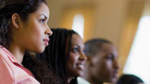 a group shot of four students watching an event