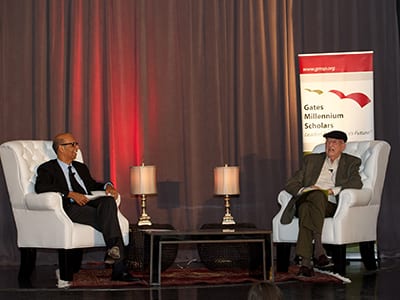 Michael Lomax and Bill Gates senior talking together on stage