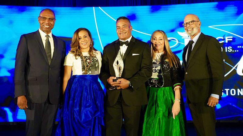 Dr. Lomax and four attendees pose together onstage