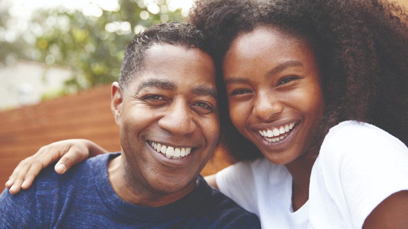 Father and Daughter smiling