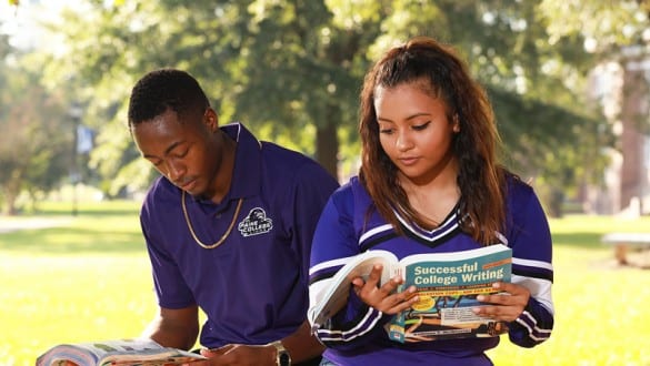 2 Paine College students reading outside on campus