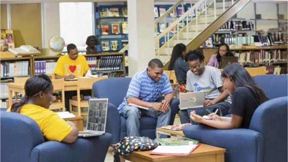 Group shot of Jarvis Christian College students studying with laptops in library