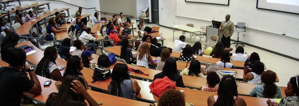 Professor speaks to lecture hall full of college students