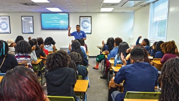 Classroom with professor speaking to room full of college students