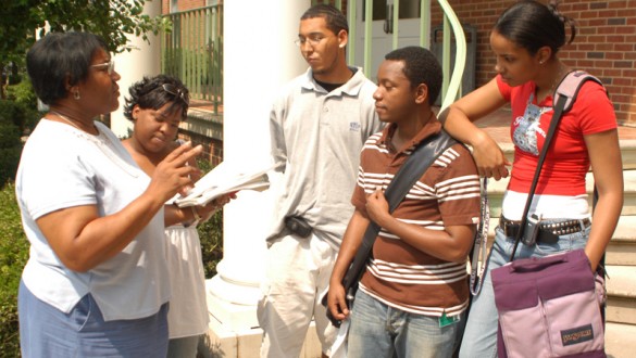 4 Paine College students talking to a professor outside on campus