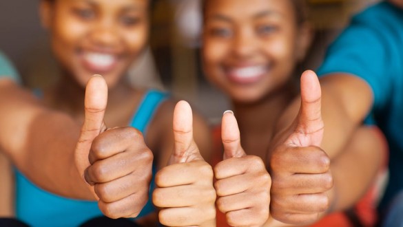 4 students with thumbs up