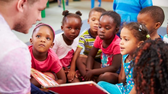 Man reading to a group of young children