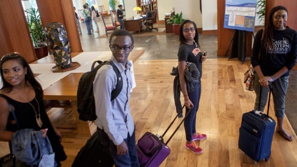4 college students with their suitcases preparing to travel