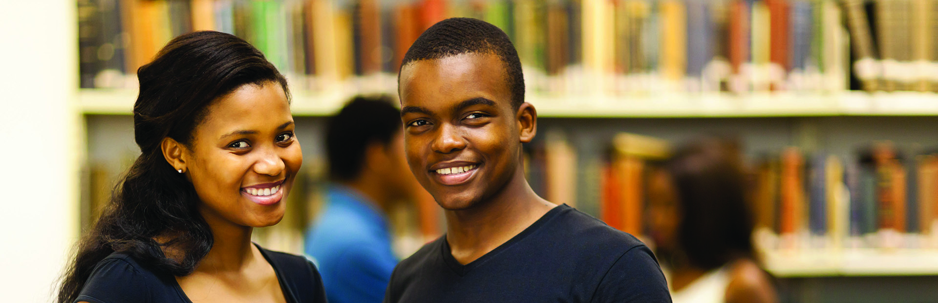 Photo of two African American students in library
